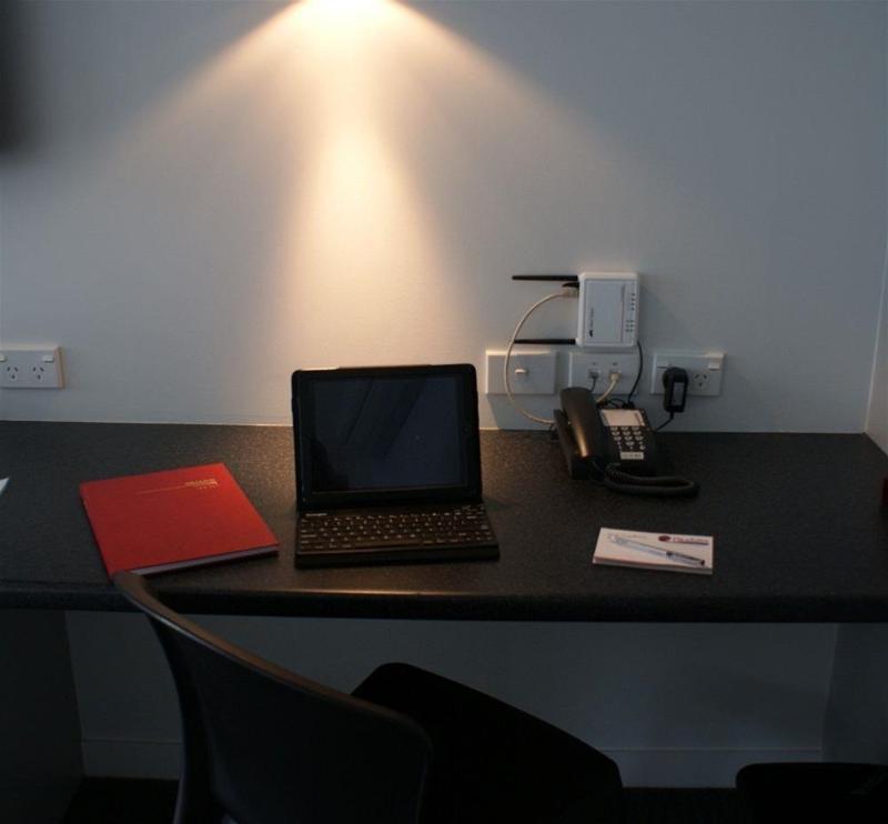 Pukekura Motor Lodge New Plymouth Exterior photo A typical hotel room with a phone, a laptop and a book